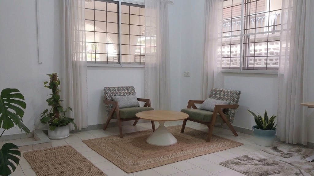 A peaceful seating nook with two armchairs, a coffee table and indoor plants